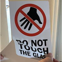 Installing a do not touch label on glass