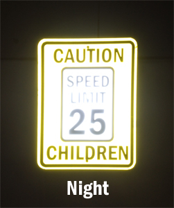 Reflective speed limit sign visible in the night