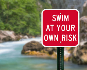 Swim at your own risk sign