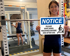 Wipe down machines before and after use sign