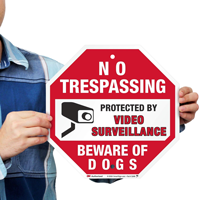 No trespassing sign with dog warning