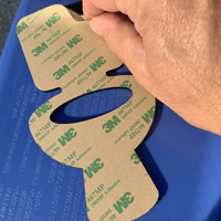 Restroom sign with adhesive installation kit