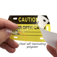 Self-laminating fiber optic cable markers
